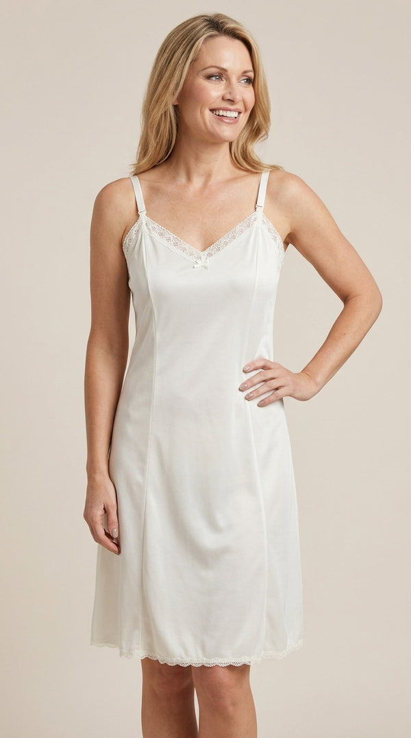 Woman wearing a ivory full slip against a beige background