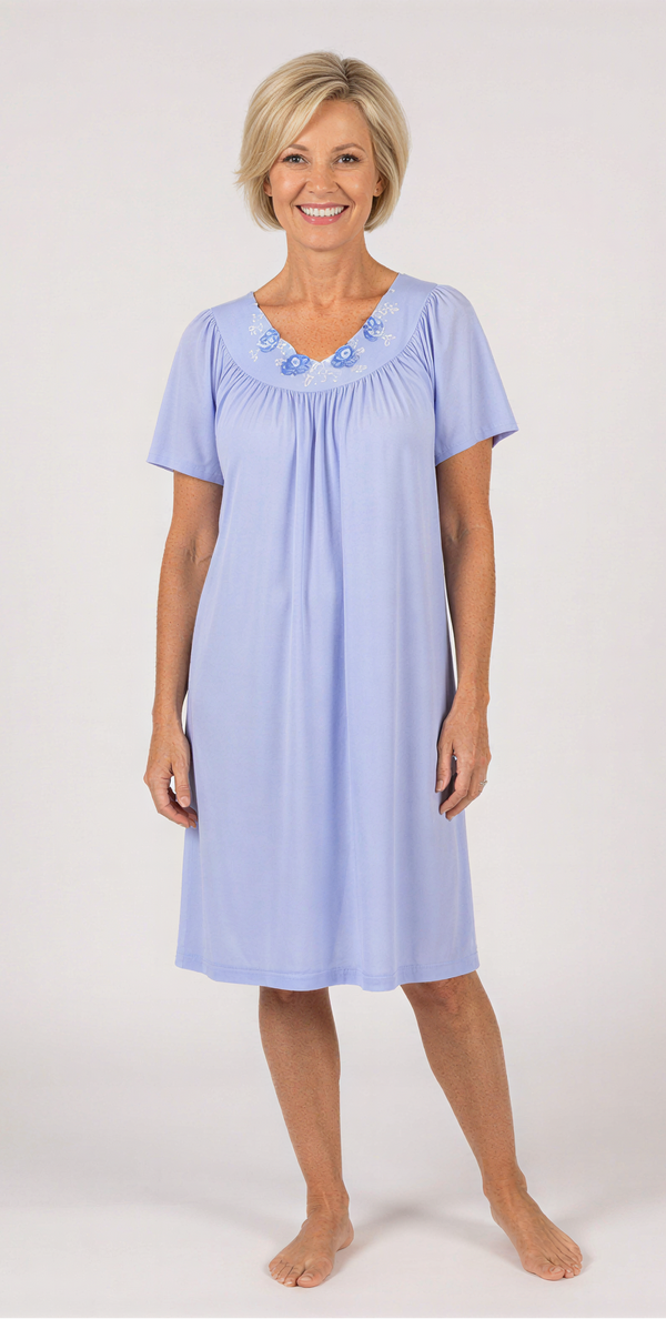 Woman wearing a light blue nightgown against a white background