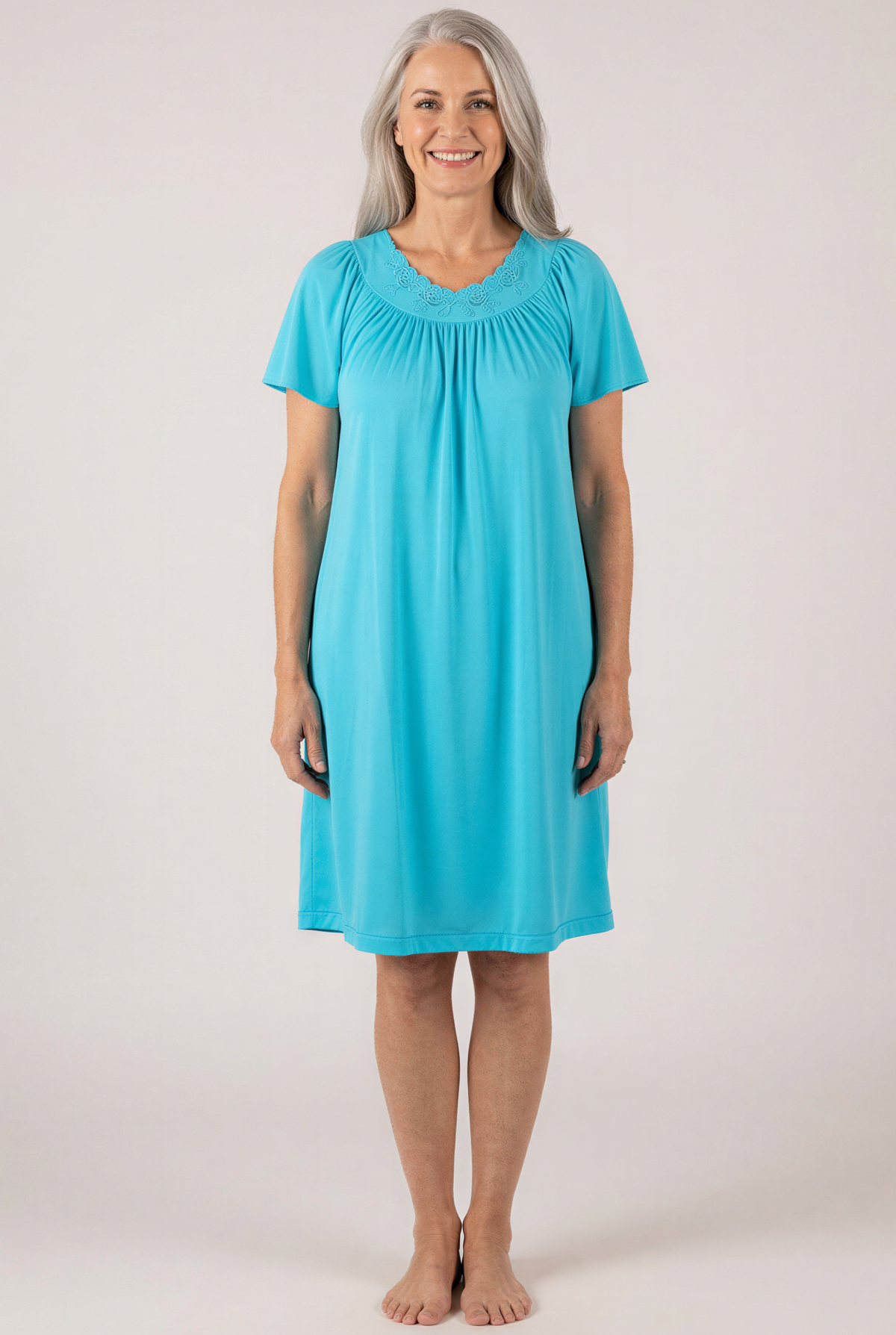 Woman wearing a Petals 36280  Turquoise Flutter Sleeve Nightgown against a white background