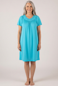 Woman wearing a Petals 36280  Turquoise Flutter Sleeve Nightgown against a white background