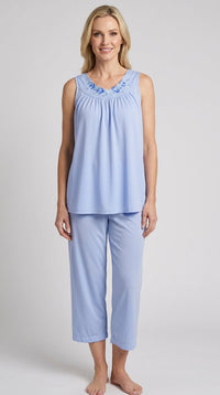 Woman wearing a Lilac Petals sleeveless pajama set on a plain background